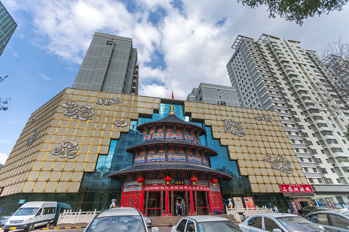 Urumqi, Xinjiang, China - October 4, 2016: Urumqi downtown street view. quanjude roast duck restaurant and office buildings on the background,