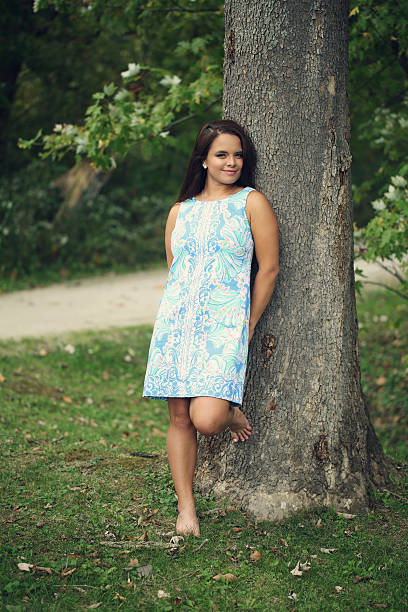 istock Teen Girl Leaning on Tree 620978174