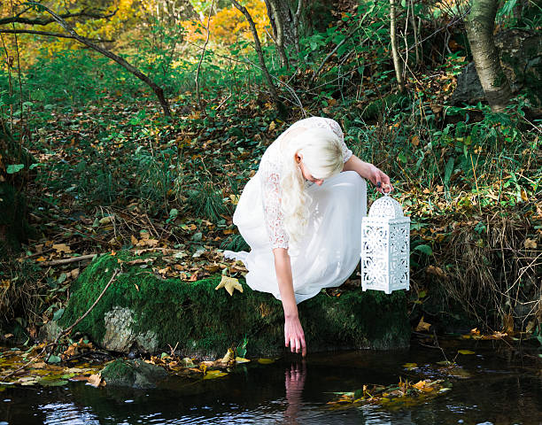 istock woman at a forest brook shore 620978948