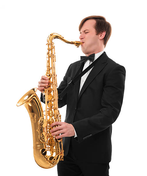 istock Saxophonist in a tuxedo plays music on sax. 620980524