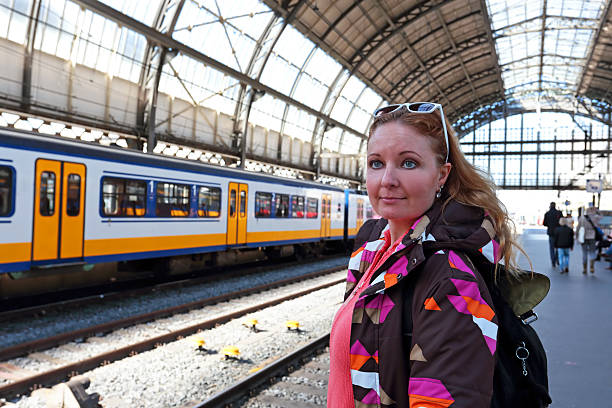 istock Young native dutch woman waiting for the train 620981044