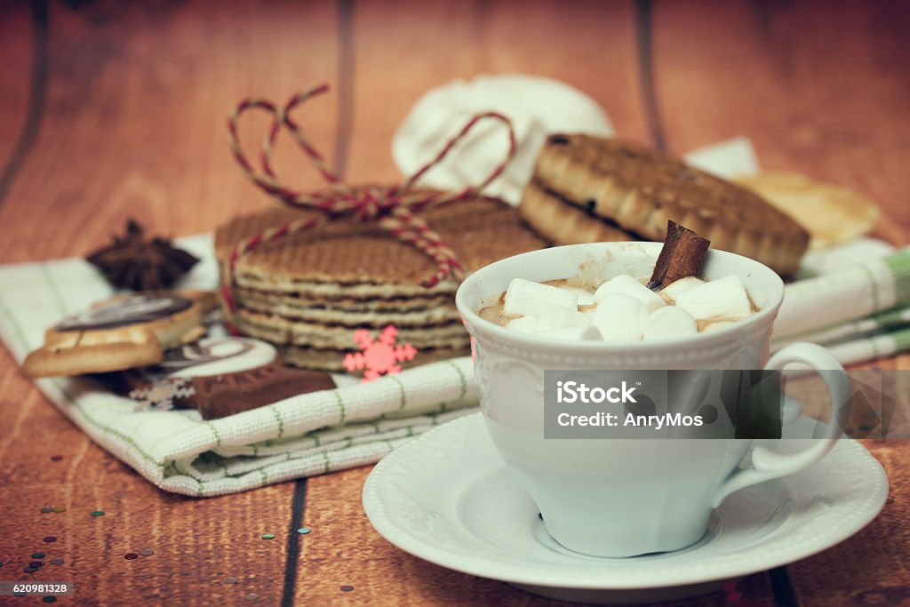 Cup with a hot drink, biscuits and waffles Cup with a hot drink, biscuits and waffles on wooden background Baked Pastry Item Stock Photo