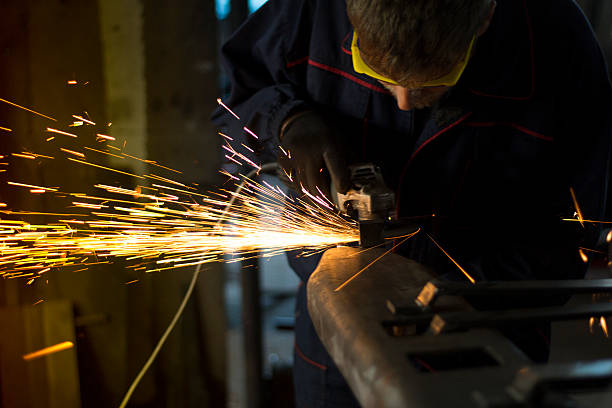 istock Factory worker using electric grinder in METAL INDUSTRY. 620982422