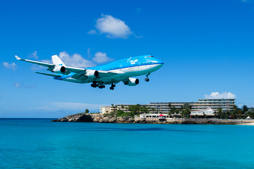 Maho Beach, Saint Maarten - November 15, 2013: A KLM Boeing 747 come in for a landing at Princess Juliana International Airport in St. Maarten.