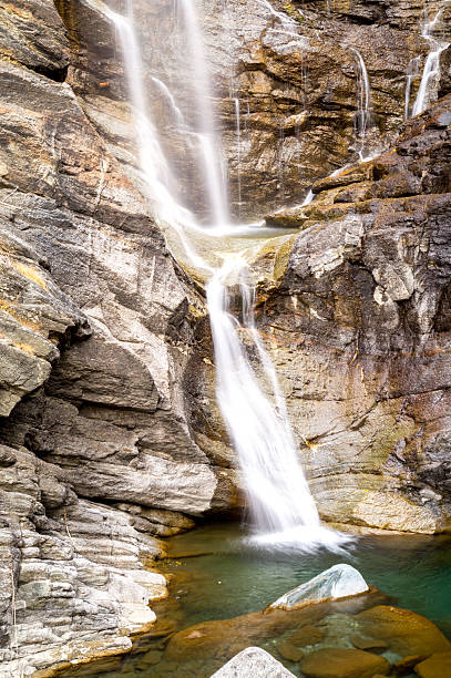 istock waterfall in the mountains and the autumnal trees, long exposure 620984056