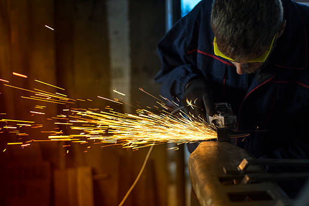 istock Worker grinding a metal part in his workshop. 620984508