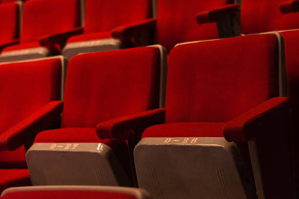 istock Red chairs in theater room 620984580