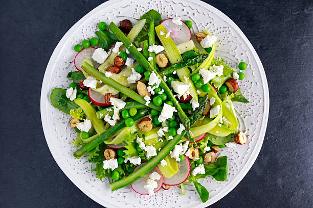 istock Fresh Green Asparagus salad witch Goat Cheese, peas, radishe, zucchini 620986016