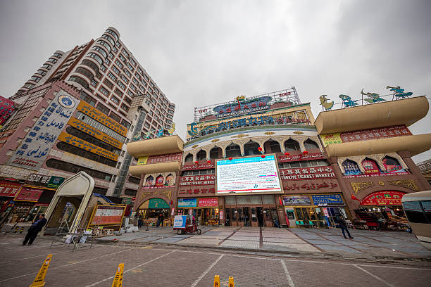 Urumqi, Xinjiang - October 13, 2016:  A lot tourists are in the Bazaar.Stores, restaurants are inside. Business buildings and Incidental people are on the background.