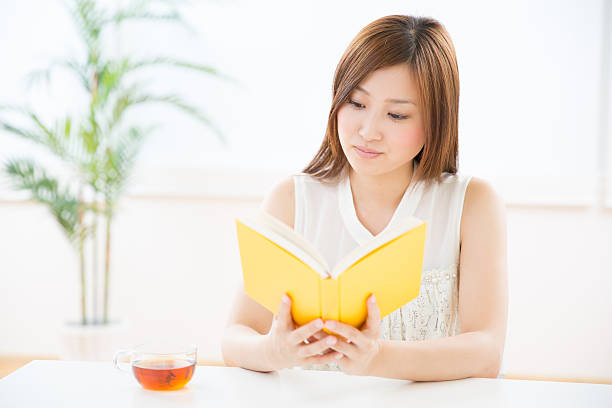 istock Japanese woman reading a book 620989852