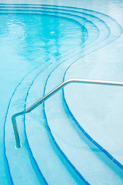 deszcz kropla rippples w basen z zaokrąglonymi kroki. - resort swimming pool swimming pool poolside curve zdjęcia i obrazy z banku zdjęć