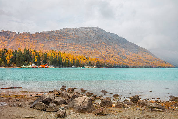 The tree color is changed to yellow. Lake in the front and mountain on the back.