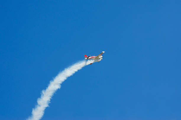 istock Plane left in trail of smoke in the blue sky. 620990502