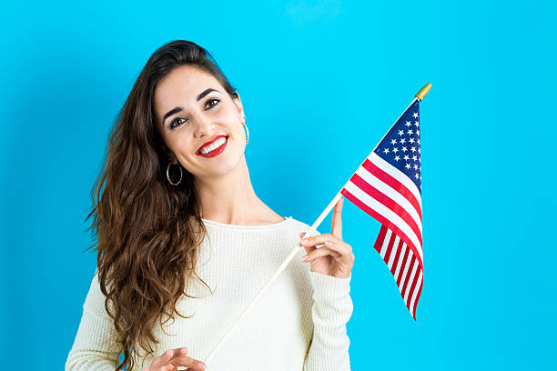 istock Young woman holding American flag 620991002