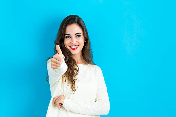 istock Happy young woman giving a thumb up 620991004