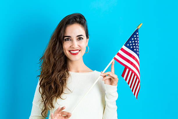 istock Young woman holding American flag 620991006