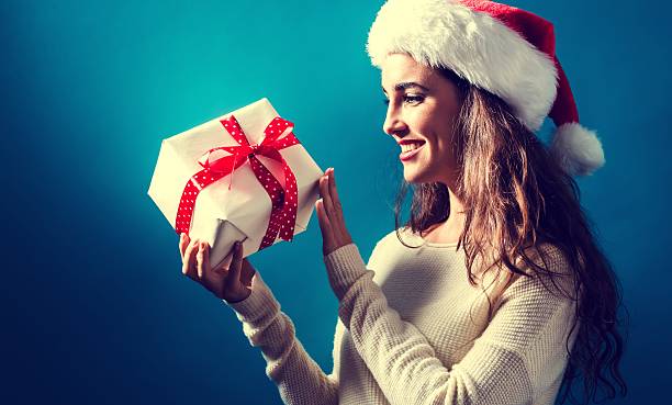 istock Young woman holding a Christmas gift 620991150