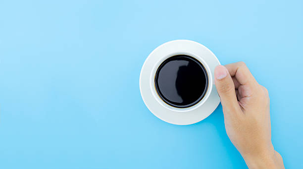 istock male hand hold a cup of coffee. 620993706