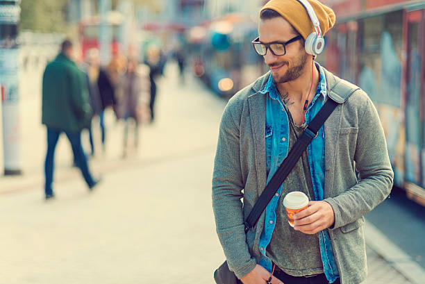 istock handsome man enjoying the music while walking in the city 620994672