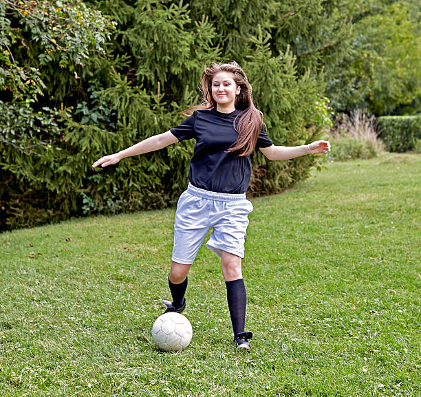 istock Girl kicking Soccer Ball 620995868