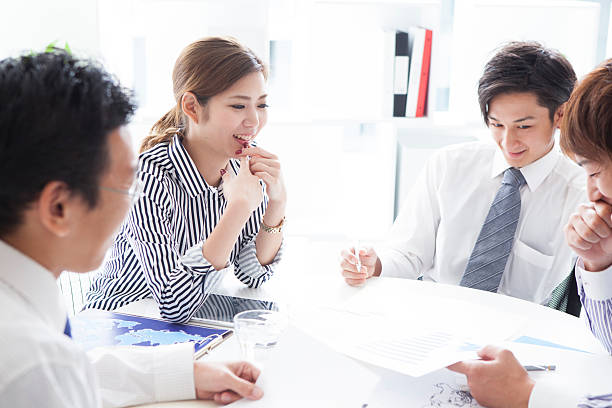 istock People who are meeting the material to reference 620998258