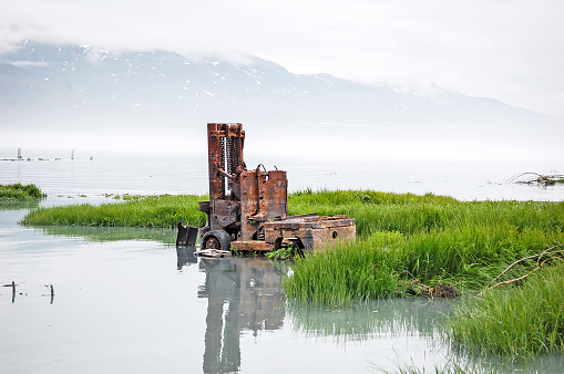 An old lift sits in the bay near Valdez, Alaska.  Abandoned in the site of the 