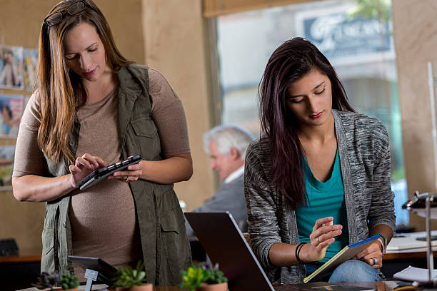 istock Young women work on project together in the office 621099786