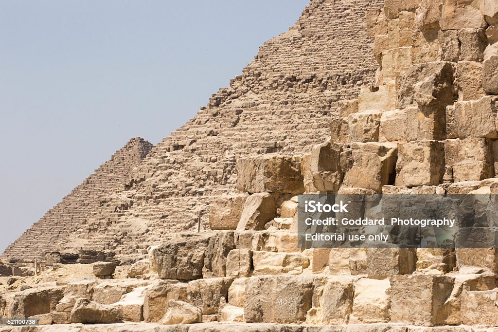 Egypt: Three Pyramids of Giza Giza, Egypt - July 18, 2016: The three main pyramids at the Giza complex, including (foreground to background) the Pyramid of Khufu (aka the Great Pyramid of Giza or Pyramid of Cheops), the Pyramid of Khafre (aka Pyramid of Chephren) and the Pyramid of Menkaure. Egypt Stock Photo