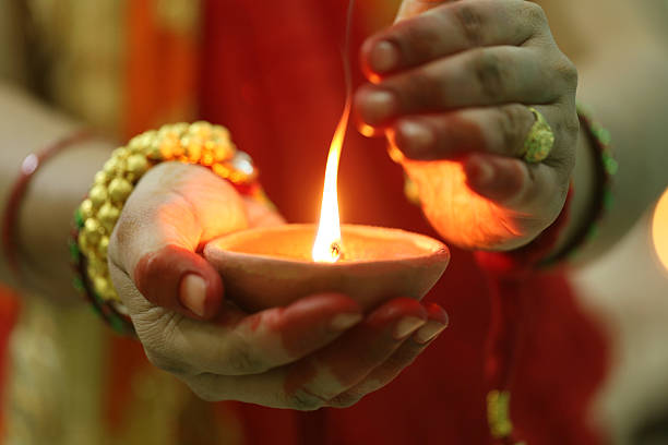 istock Indian woman holding Diwali oil lamp 621101310