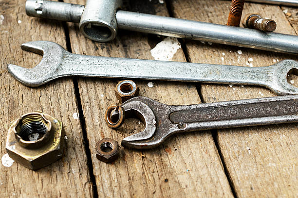 istock On weathered old wooden surface lie the , oily wrenches. 621103622