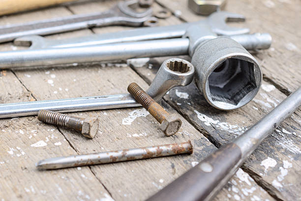 istock On weathered old wooden surface lie the , oily wrenches. 621103884