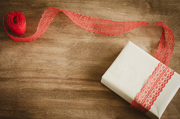 istock Vintage kraft boxe with gift, tied with red ribbon. 621105382