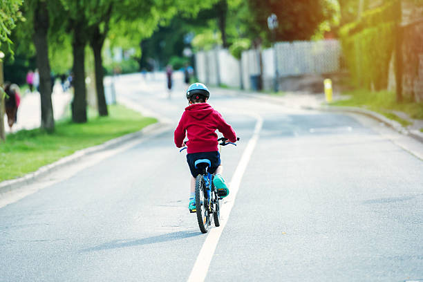 istock kid doing the bike alone in the road 621105520