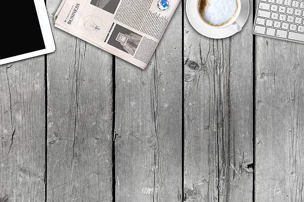 istock Daily newspaper and tablet pc on the wooden table. 621105730