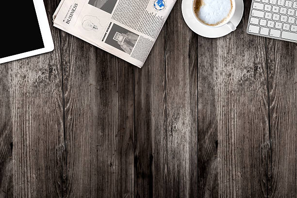istock Daily newspaper and tablet pc on the wooden table. 621105804