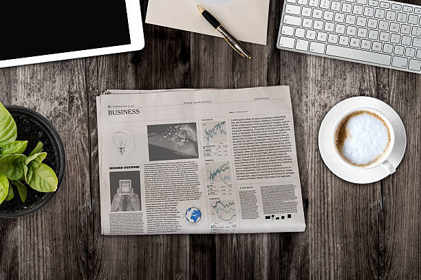 istock Daily newspaper and tablet pc on the wooden table. 621105922