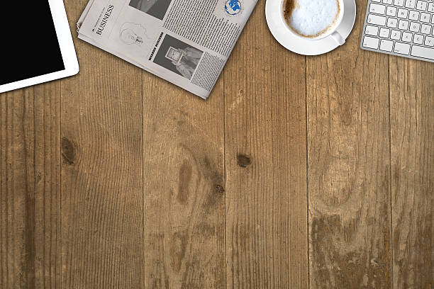 istock Daily newspaper and tablet pc on the wooden table. 621105954