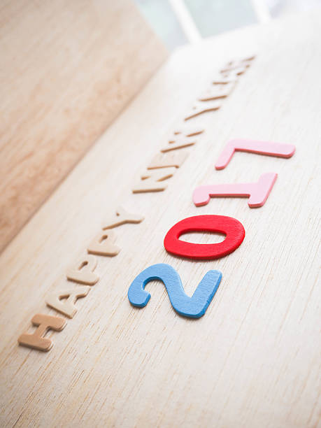 istock Happy new year 2017 word on wood background 621106236