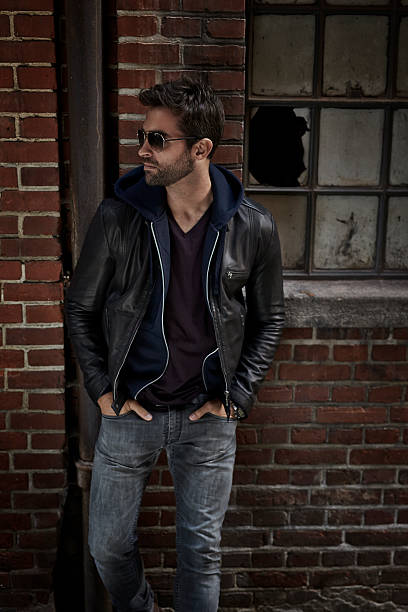 istock Man in jacket and jeans on street at night 621106426