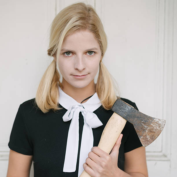 istock Creepy schoolgirl with axe 621107868