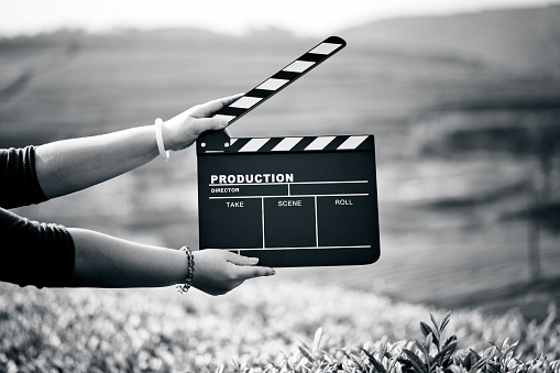 Hands holding a movie clapboard