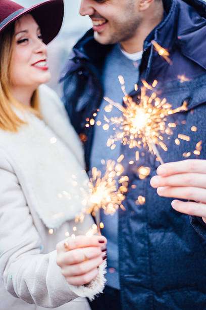 istock Couple holding sparklers on rooftop 621110914