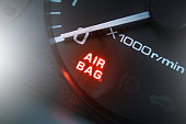 Red lighting air bag control symbol in car