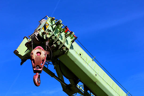 istock Closeup of an elevating crane against blue skye background 621111686