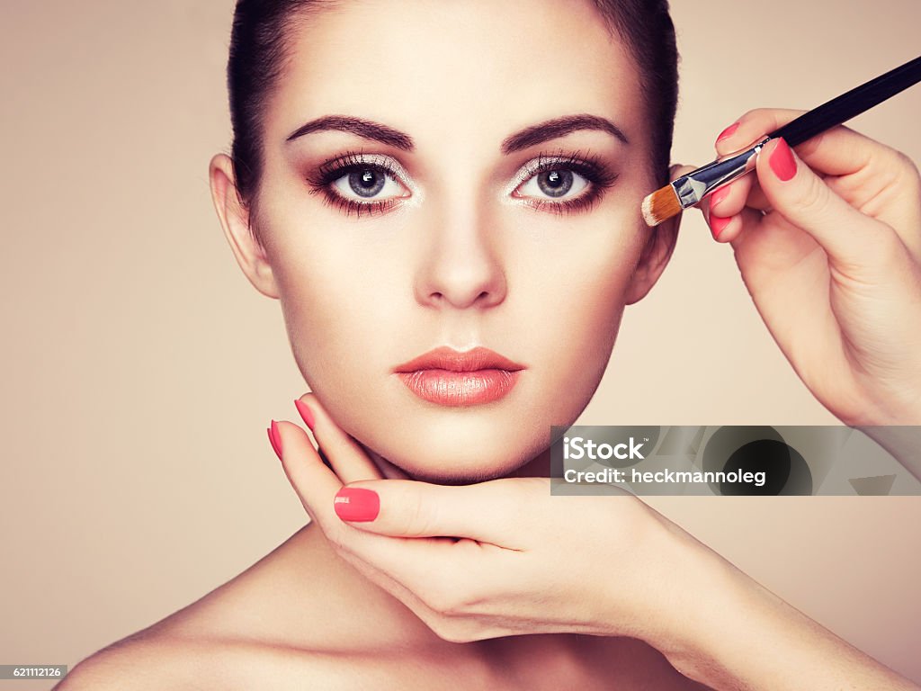 Makeup artist applies skintone Makeup artist applies skintone. Beautiful woman face. Perfect makeup. Skincare foundation Adult Stock Photo