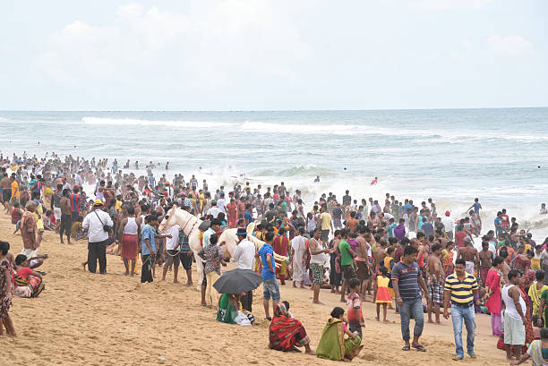 crowded sea beach,tourist enjoy summer vacation and bath on the sea  at Puri, Orissa, India