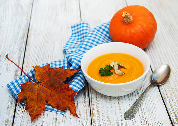istock Pumpkin soup with fresh pumpkins 621113322