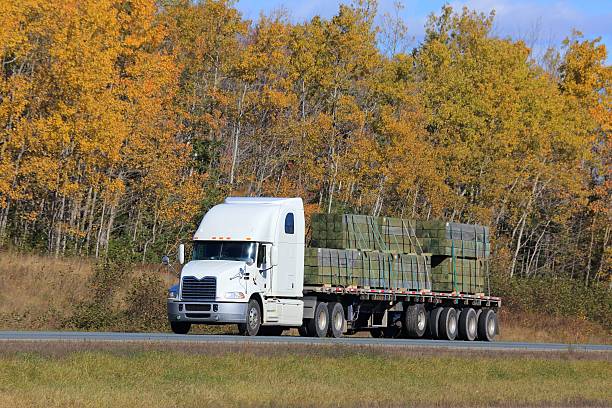 istock Semi Tractor Trailer on Interstate Highway, trees in background. 621113326