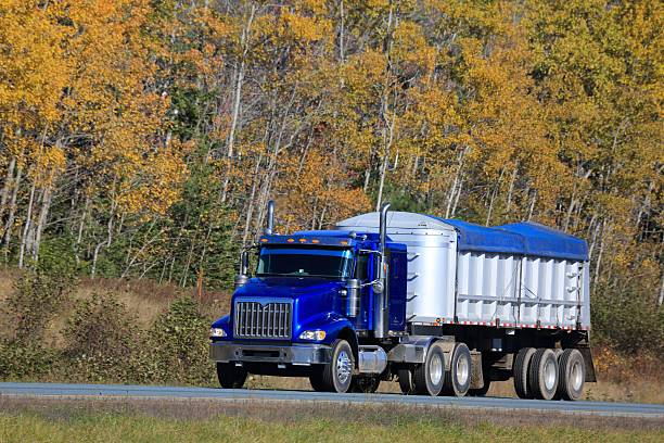 istock Semi Tractor Trailer on Interstate Highway, trees in background. 621113588
