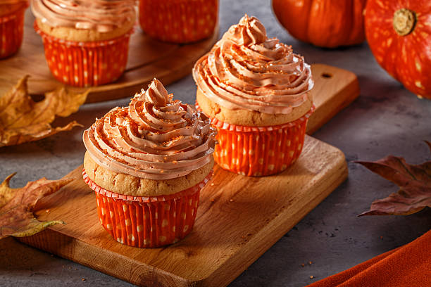 istock Pumpkin cupcakes with glitter sugar sprinkles. 621113894